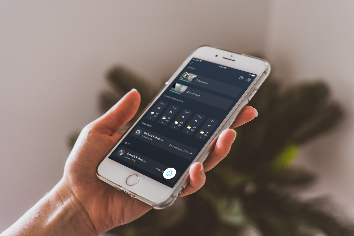 Person holding phone with wyze app open to sprinkler settings