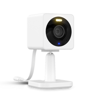 Surveillance camera with a white exterior, mounted on a stand with an indicator light.