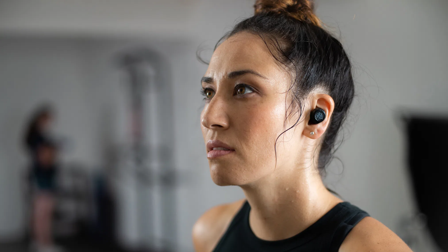 Person exercising while wearing Wyze buds and sweating.