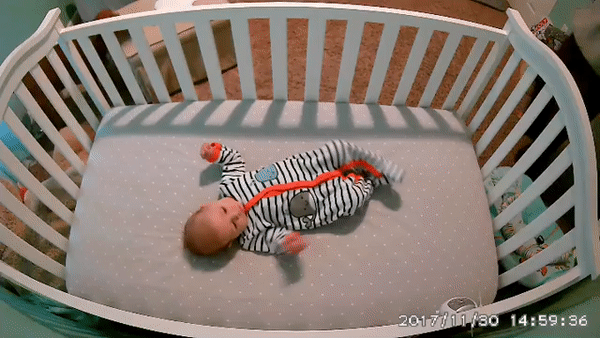 Video from a wyze camera of baby laying in a crib