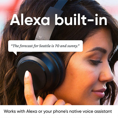 Person wearing headphones. Text overlay says, "Alexa built in, works with Alexa or your phone's native voice assistant."