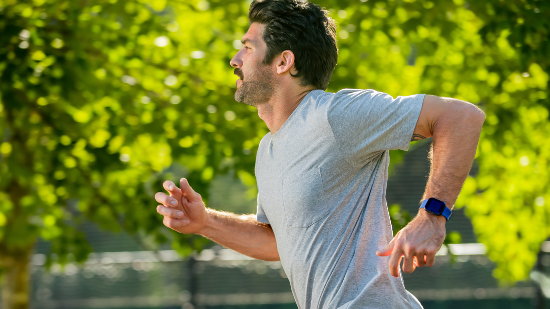 Man running outside with wyze watch 44 on his wrist