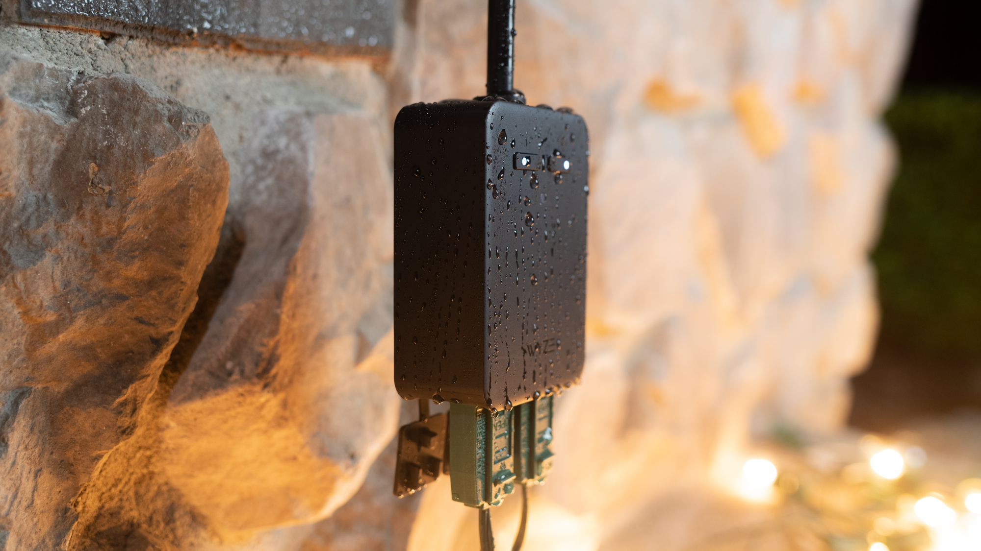 A black device with a blue cord plugged into a wall.