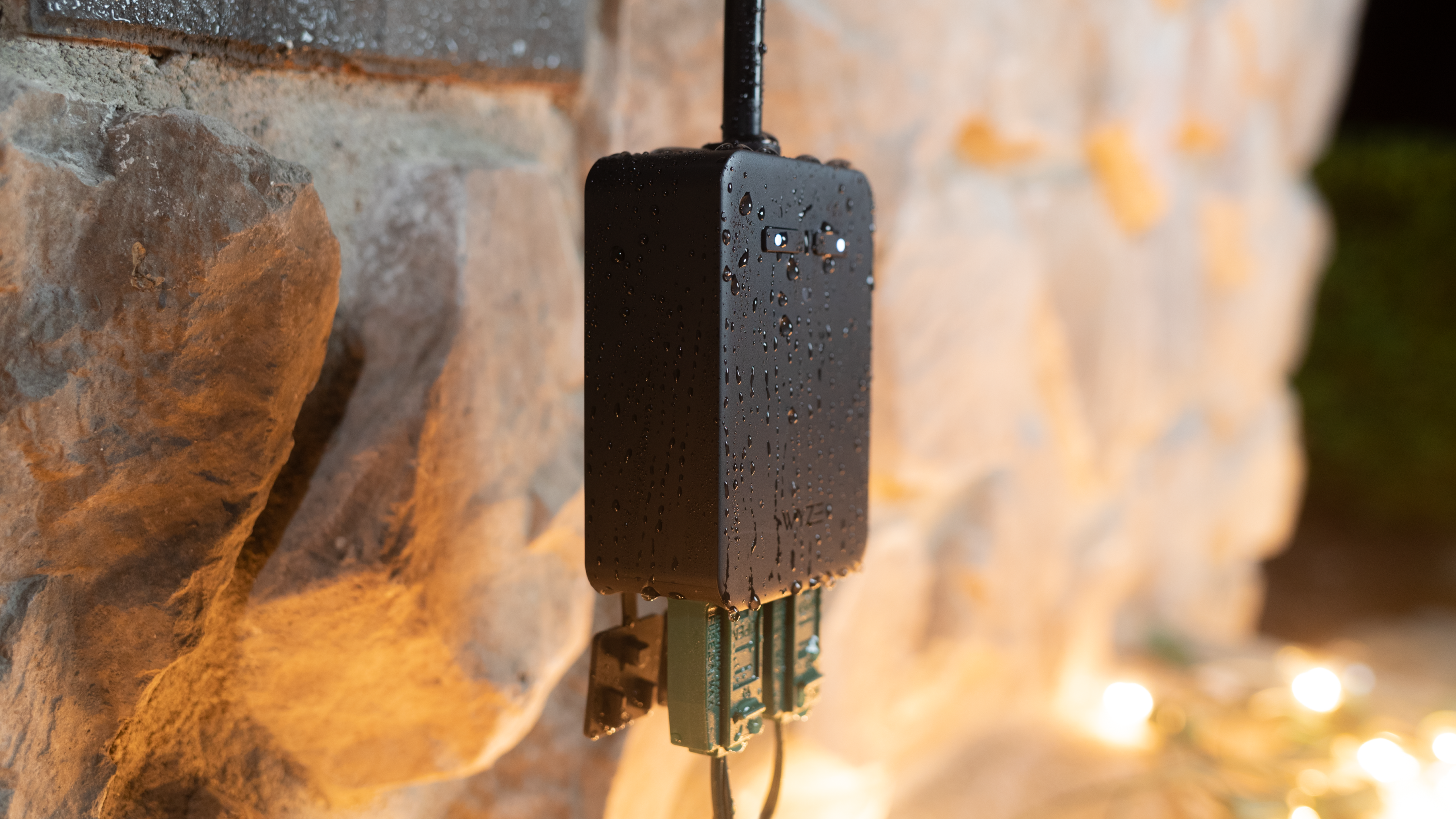 A black device with a blue cord plugged into a wall.