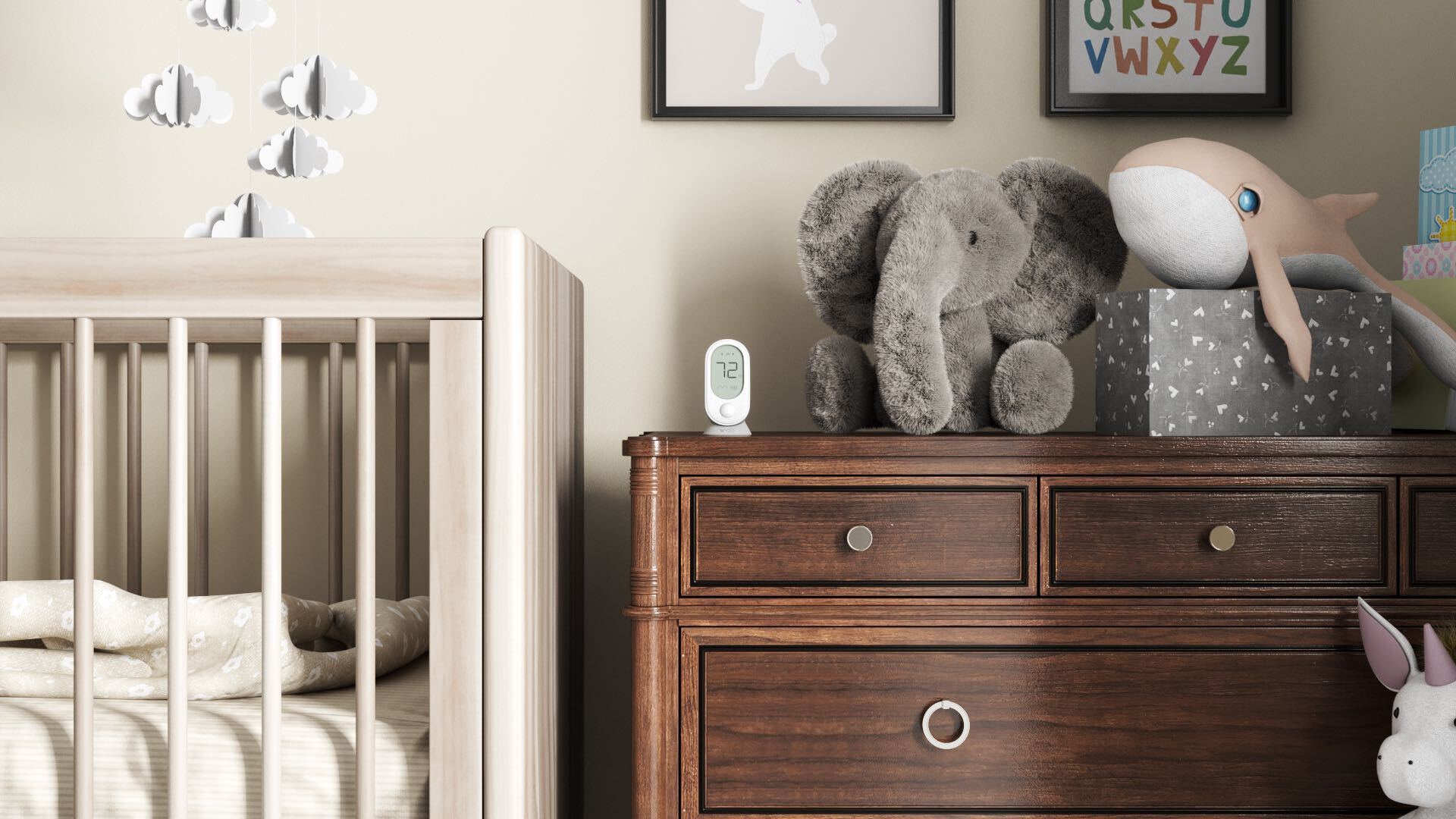 Wyze room sensor sitting on dresser next to a baby crib