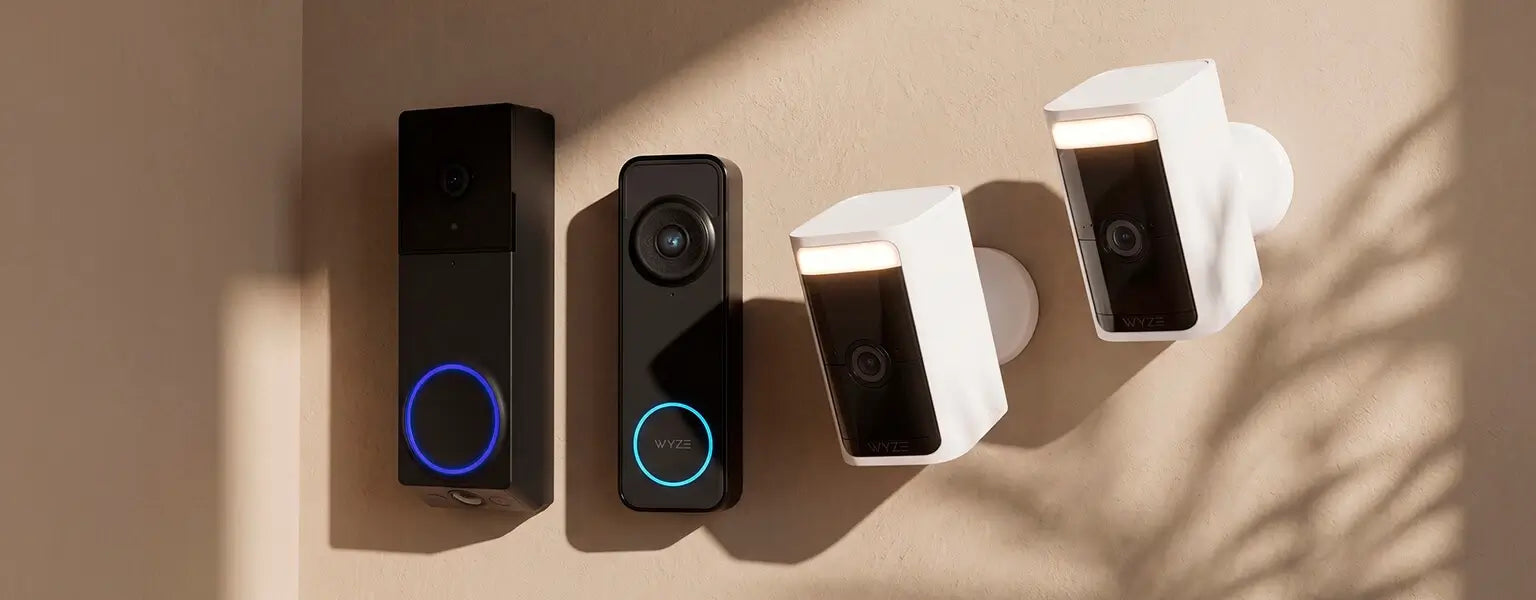 Four smart home devices on a beige surface with a soft shadow.