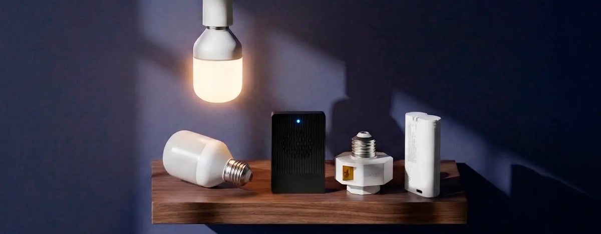 Light bulbs and electronic devices on a wooden surface with a dark background