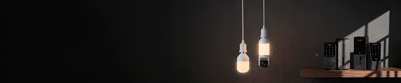 Two hanging light bulbs on a dark background with a shelf in the corner.