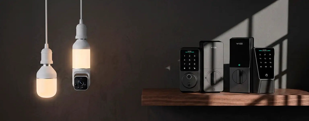 Smart home devices including light bulbs and security systems on a wooden surface with a dark background.