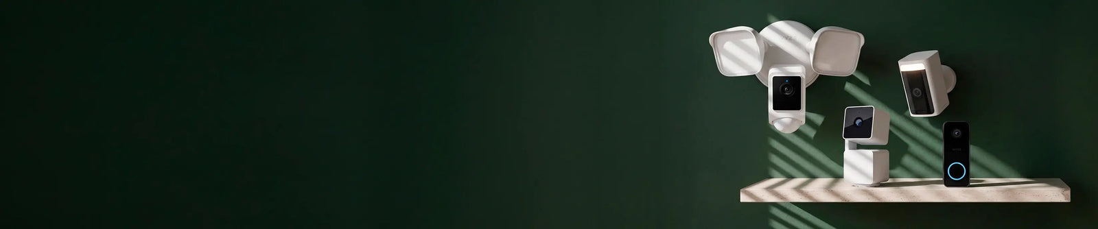 Multiple security cameras on a stand against a dark green background