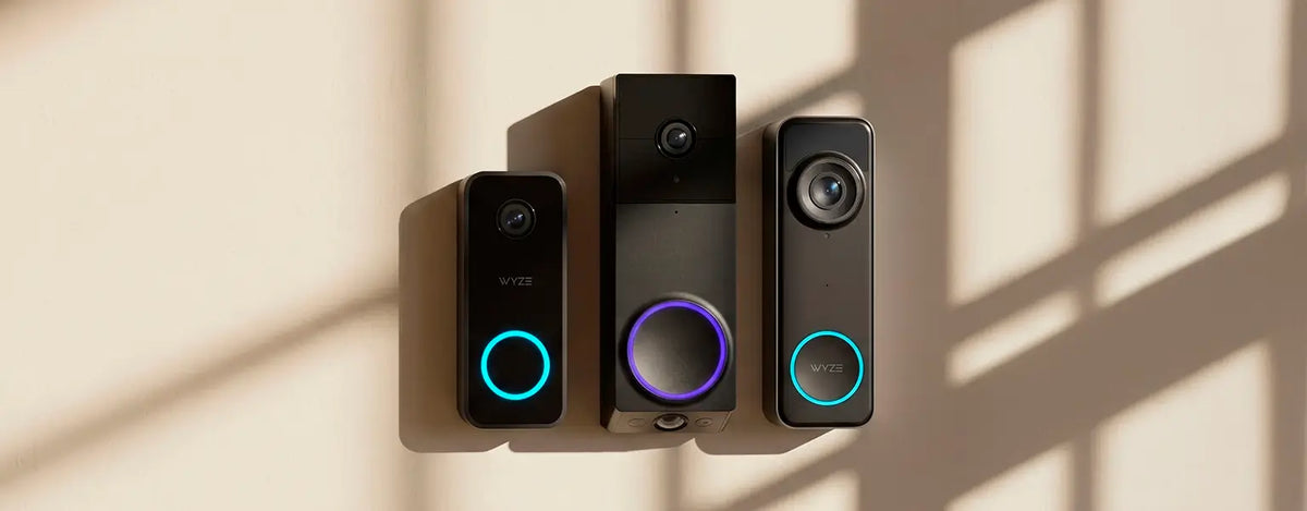 Three smart speakers with illuminated buttons on a beige wall