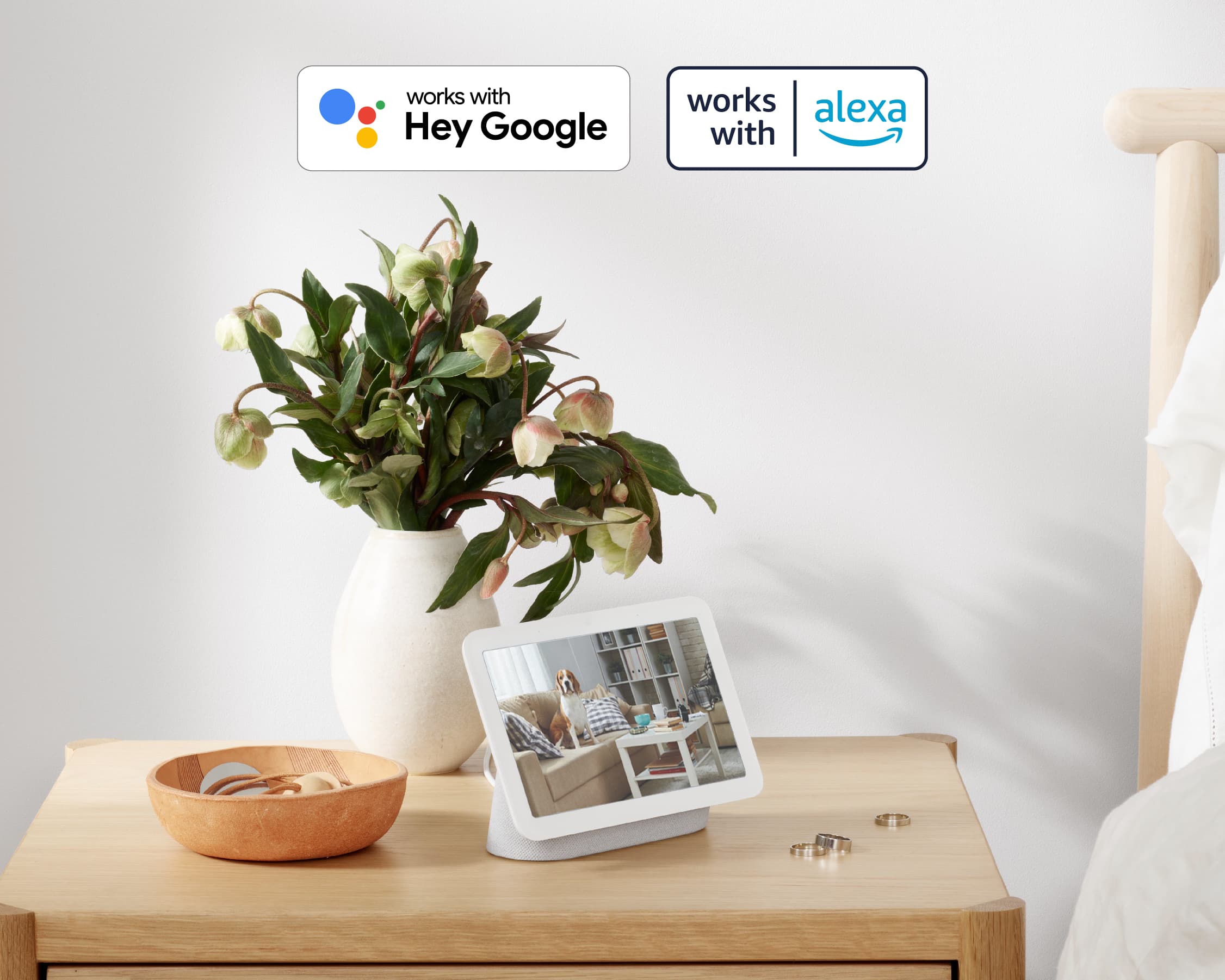 A white vase with flowers in it.