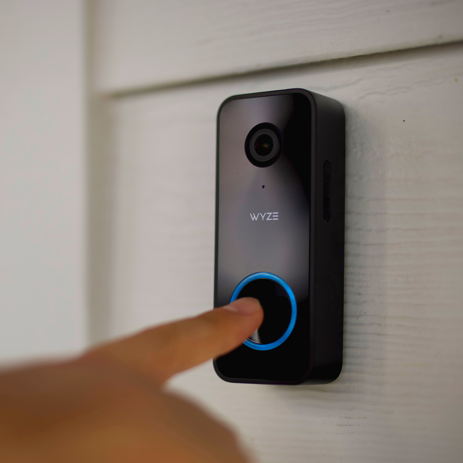 Wyze Video Doorbell v2 installed on a modern home, showing a visitor at the door