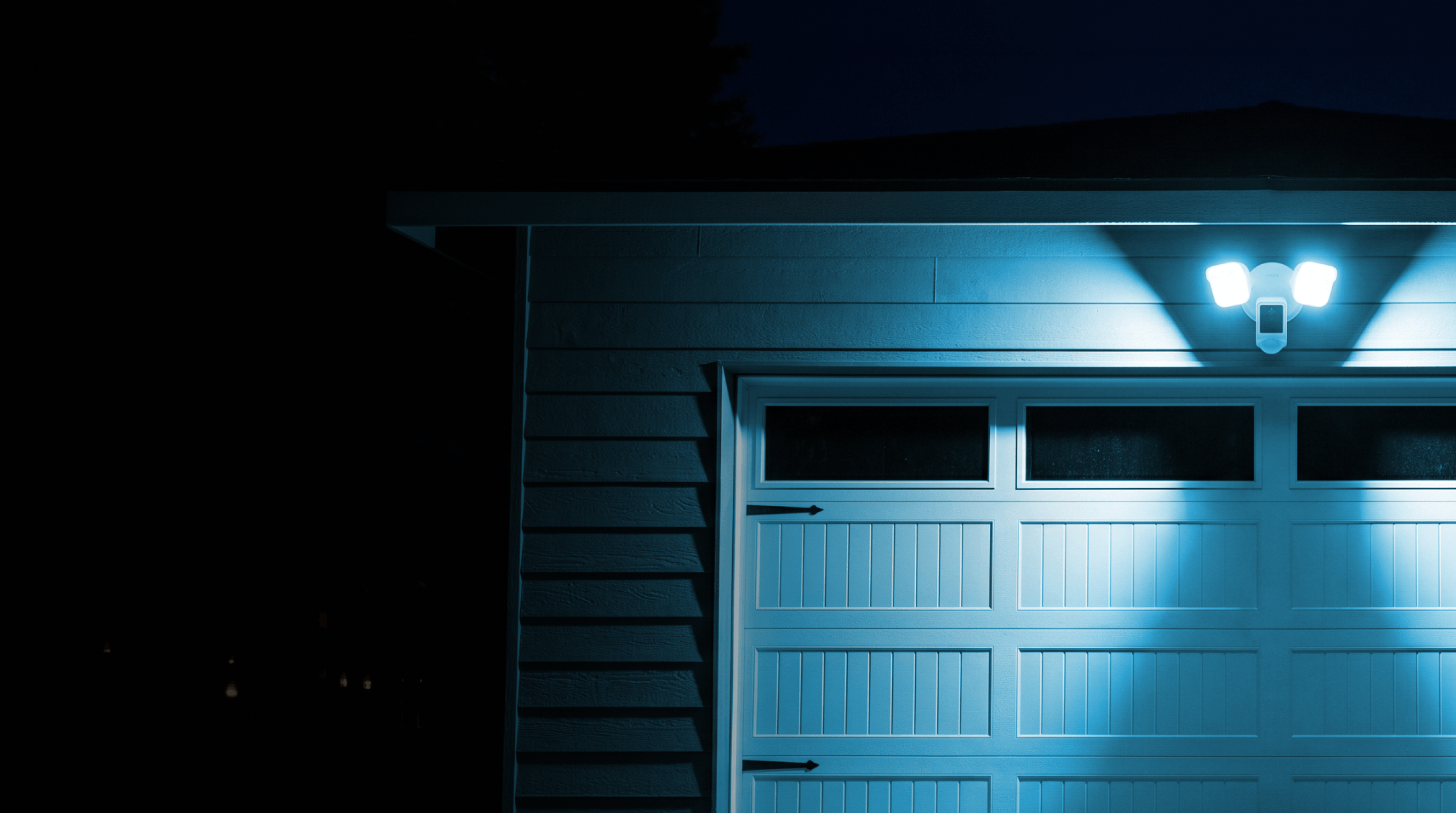 Garage door with a light fixture on a dark background