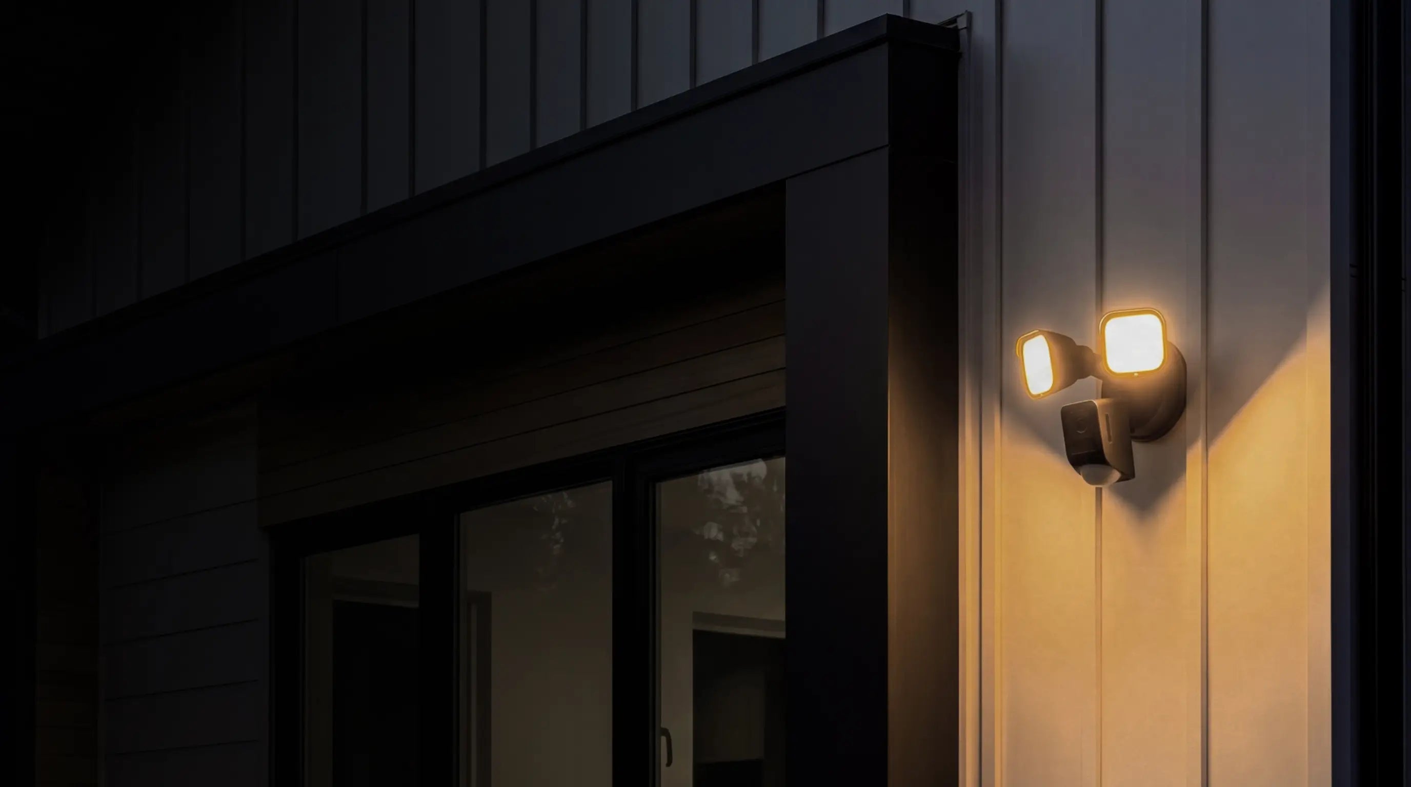 Wall-mounted outdoor light fixture on a building exterior