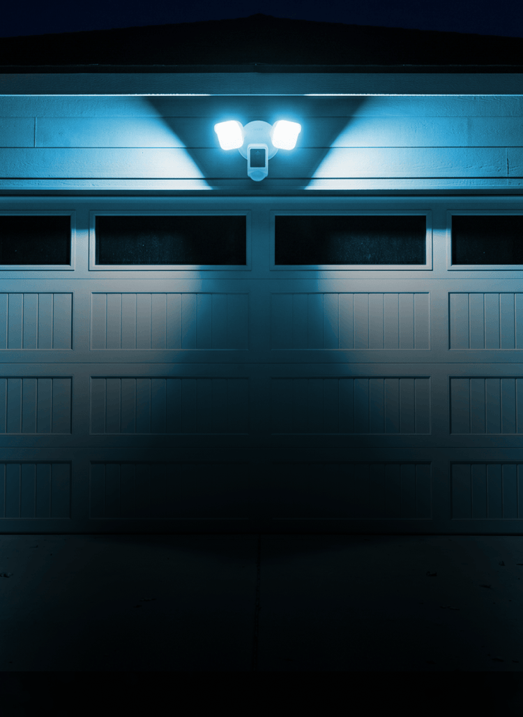 Security light fixture on a garage door at night