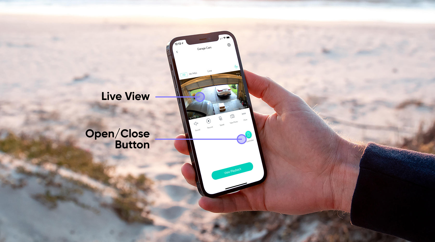 A hand holding a phone with a Wyze app open.