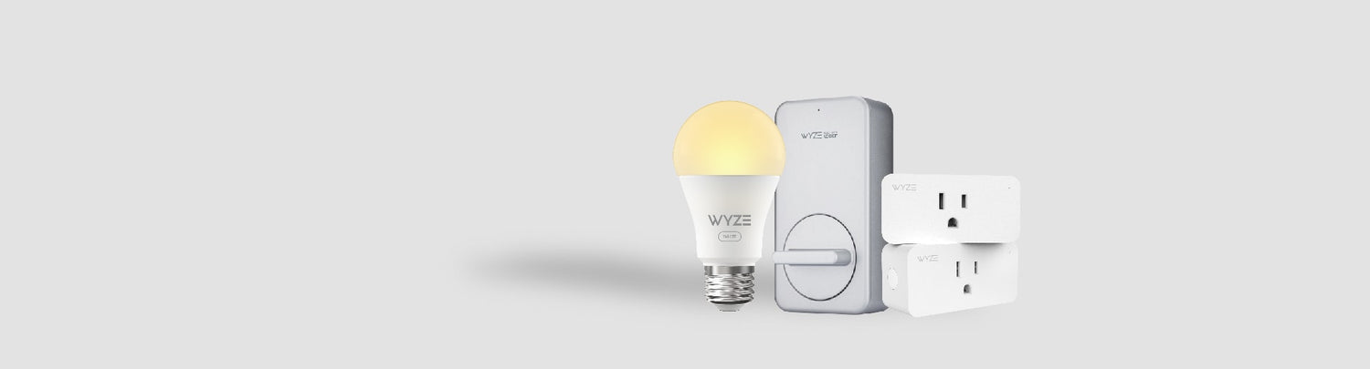 Gray background with LED light bulb with yellow glow, a lock, and smart plugs next to each other.