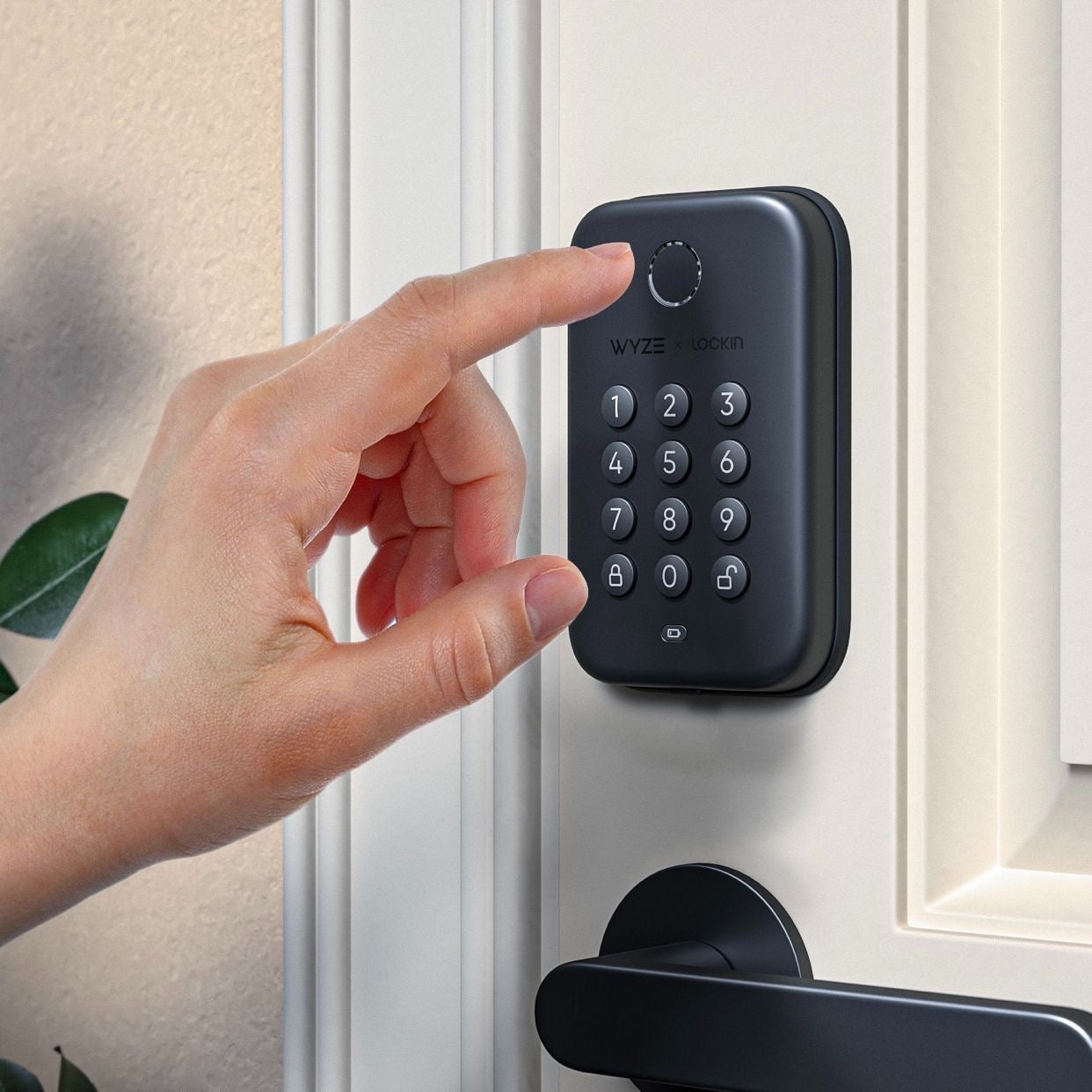 A person's finger near a fingerprint reader.