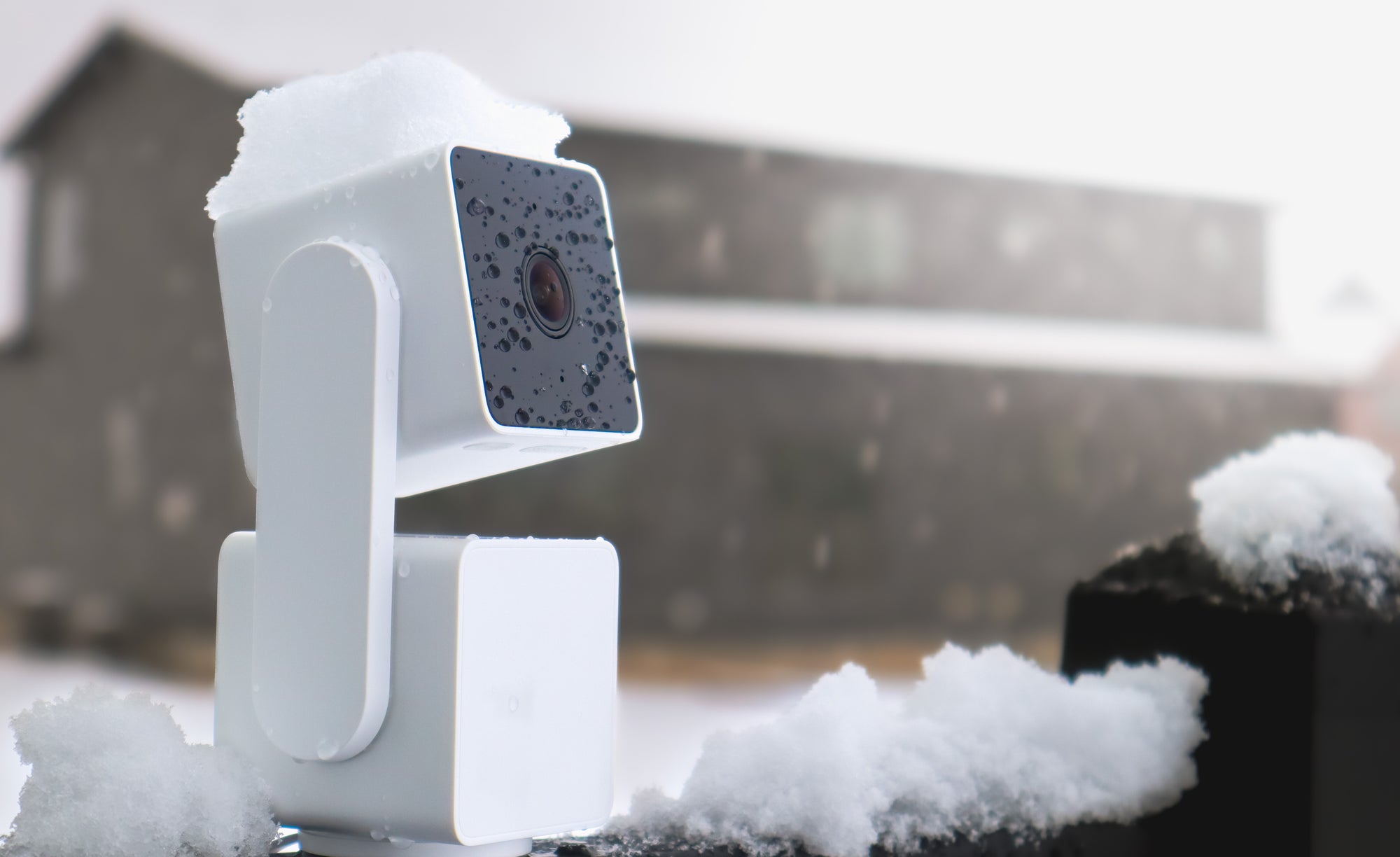 A white camera with a black lens.
