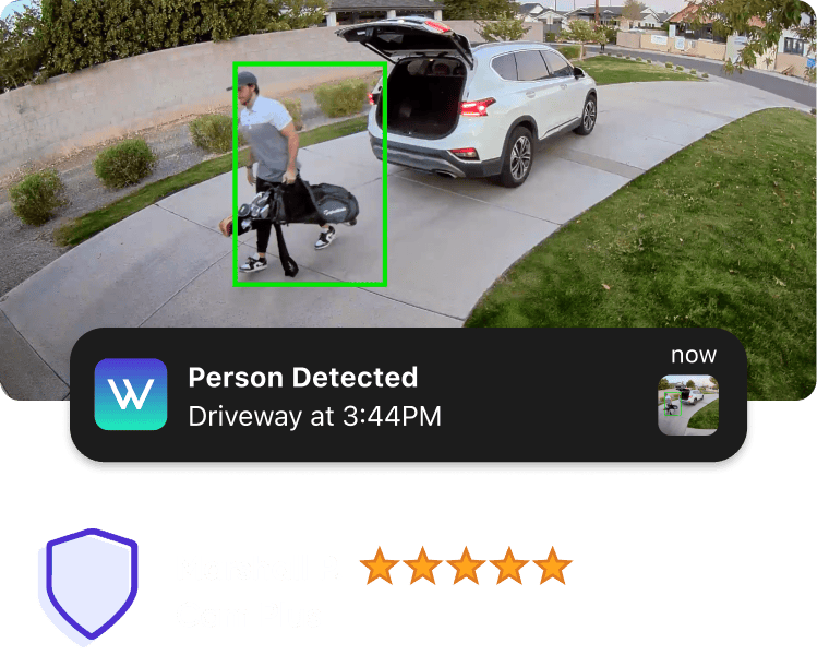 A man is holding a bag while standing in front of a car.