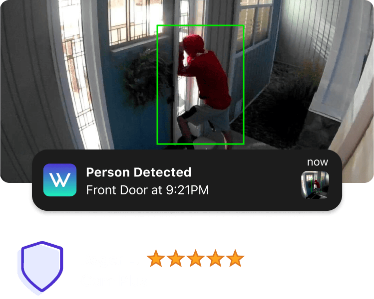 A person is standing in front of a door, which is being monitored by a security system.