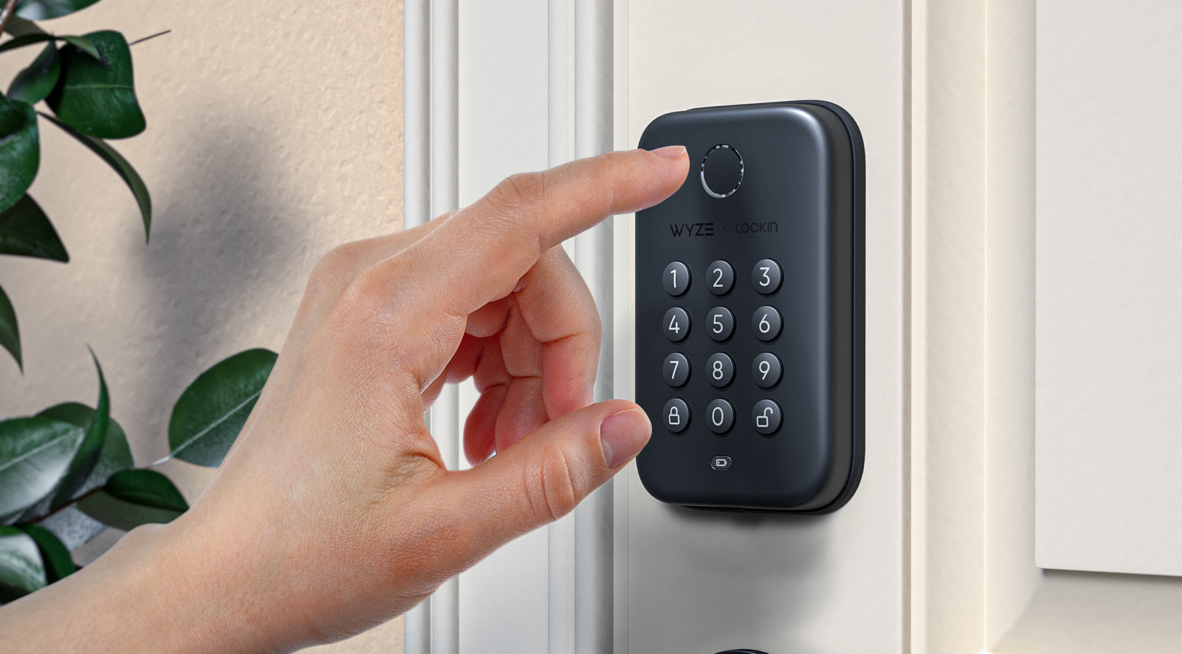 A person's finger near a fingerprint reader.