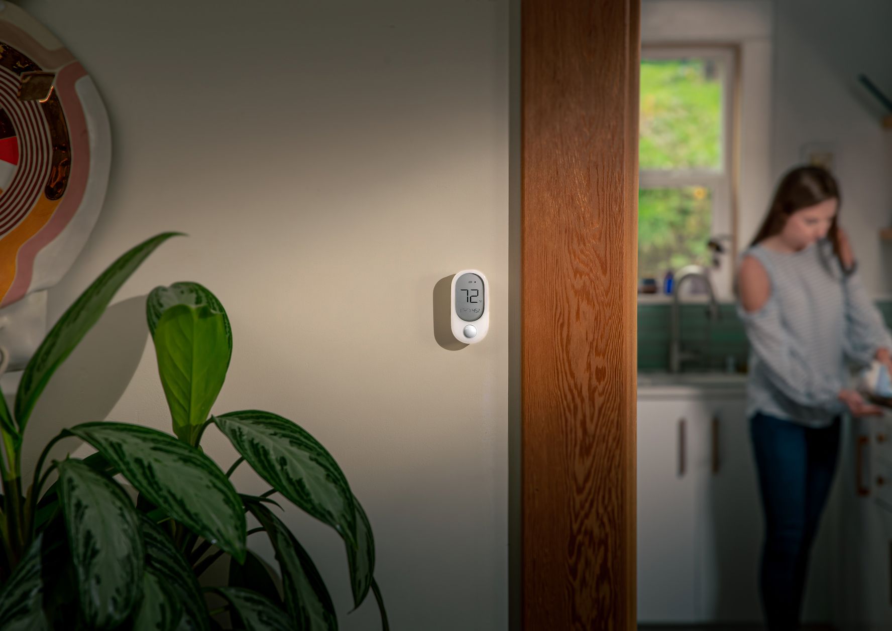 A white sensor on a wall.