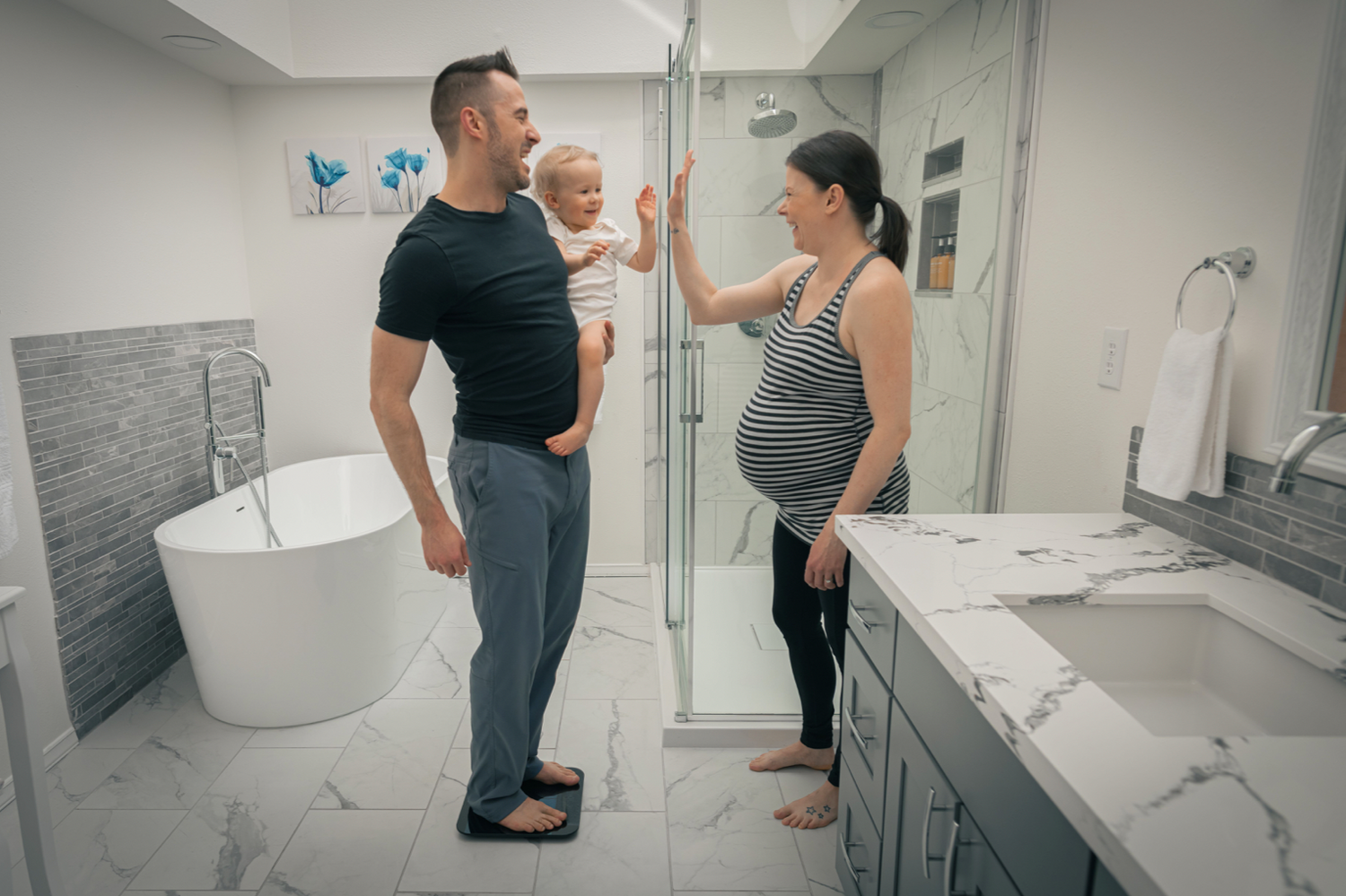 Man standing on scale while holding a child