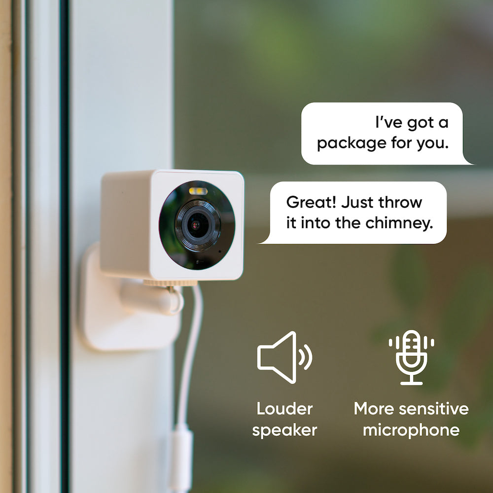 Security camera mounted to the wall with text bubbles nearby that represents 2-way audio.