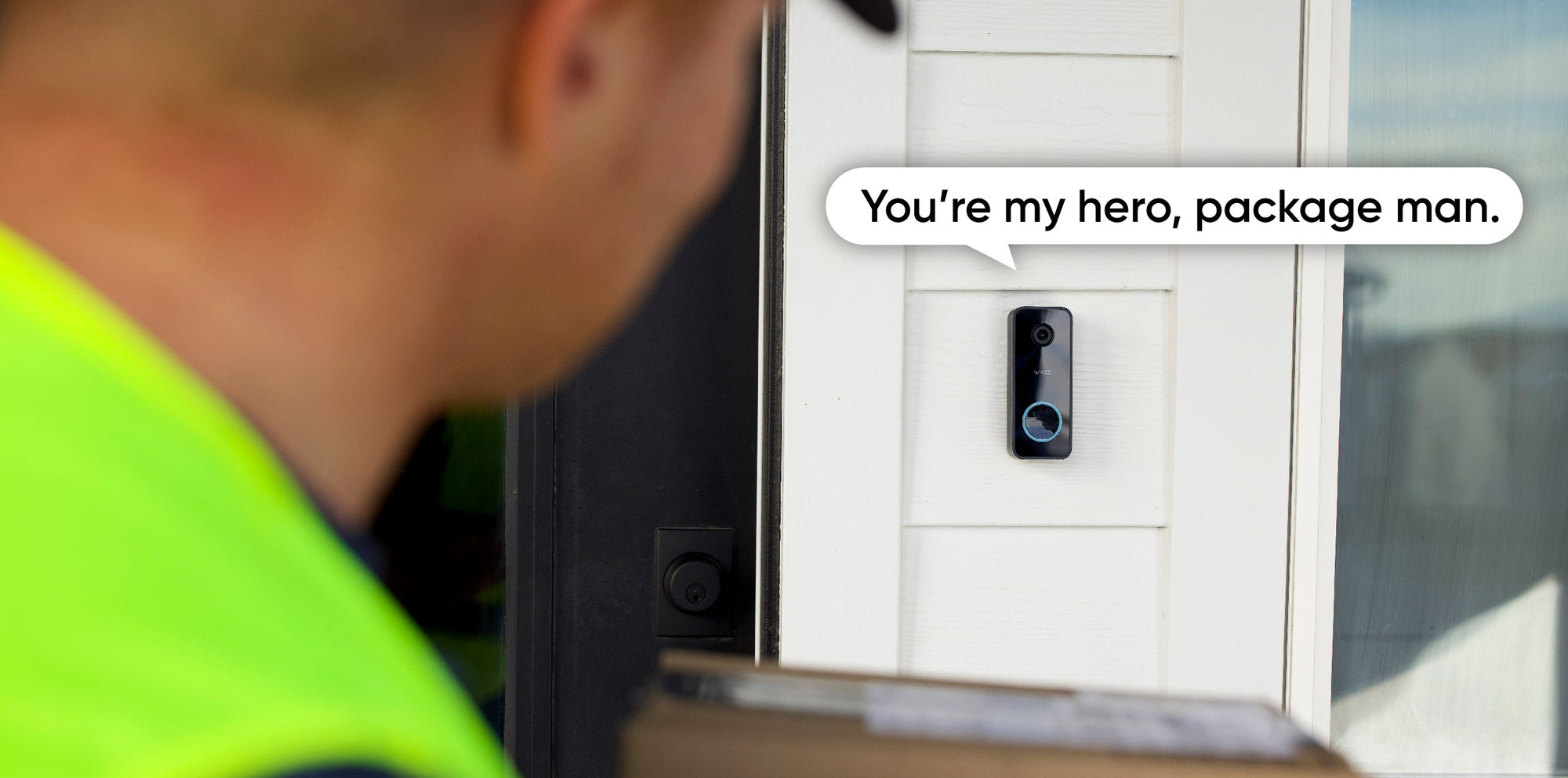 A video doorbell is attached to a white door.