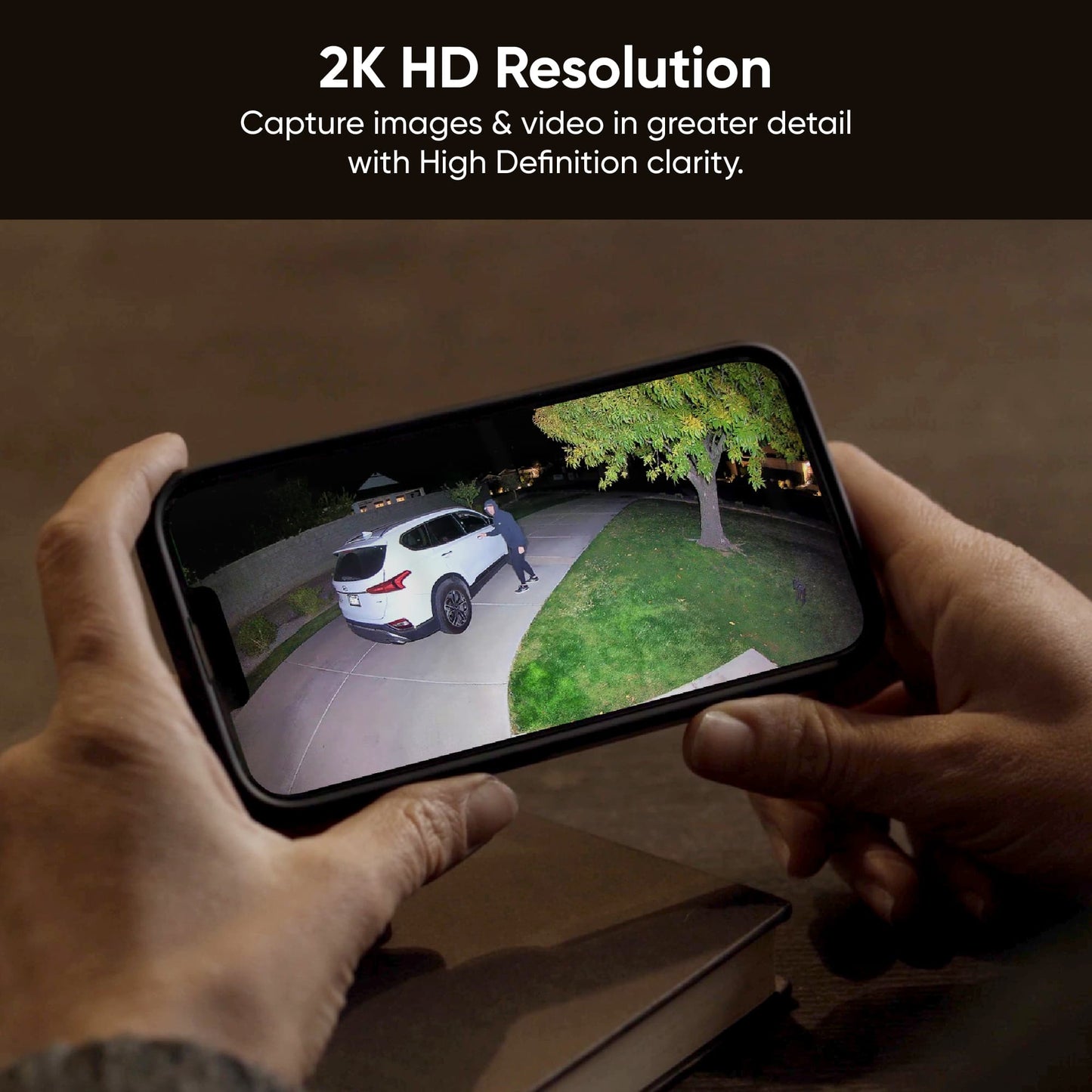 Hands holding phone looking at 2K camera footage with a 160° super-wide view