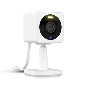 Surveillance camera with a white exterior, mounted on a stand with an indicator light.
