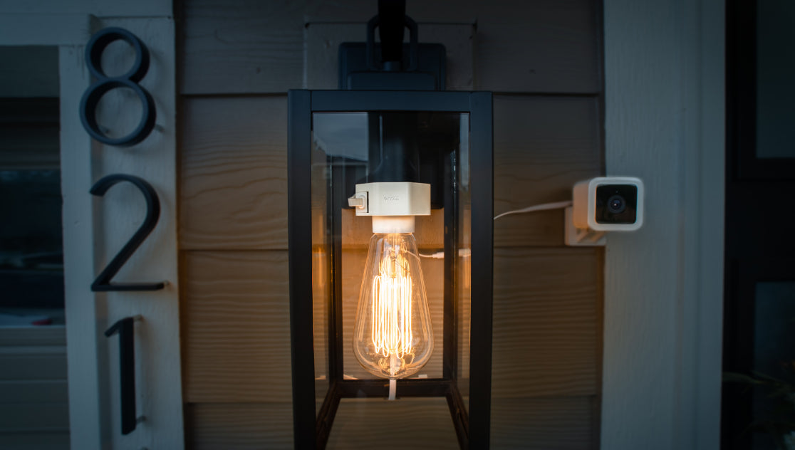 Wyze Lamp Socket powering an Edison bulb outside with a Wyze Cam v3 attached to the outlet built into the socket.