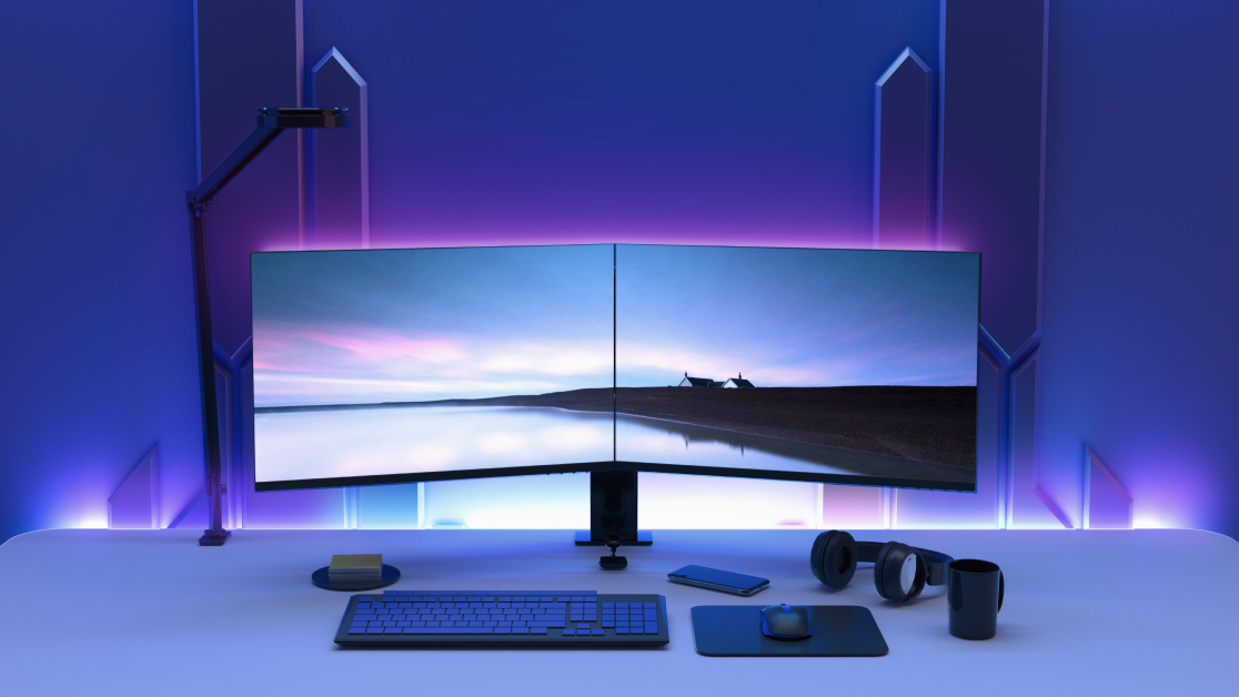 A computer desk with a keyboard and monitor.