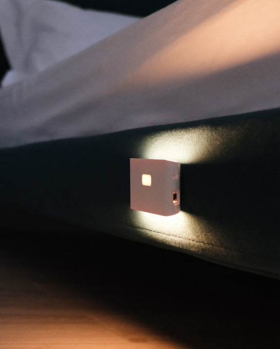Night light mounted on the side of a bed