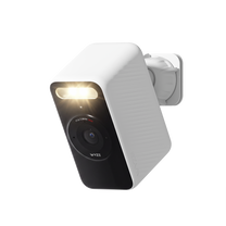 White Wyze Battery Cam shown at an angle with its spotlight illuminated and wall mount attached.