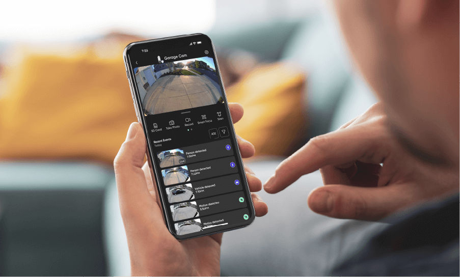 Wyze app on phone: Garage Cam live view, person/vehicle detection alerts.