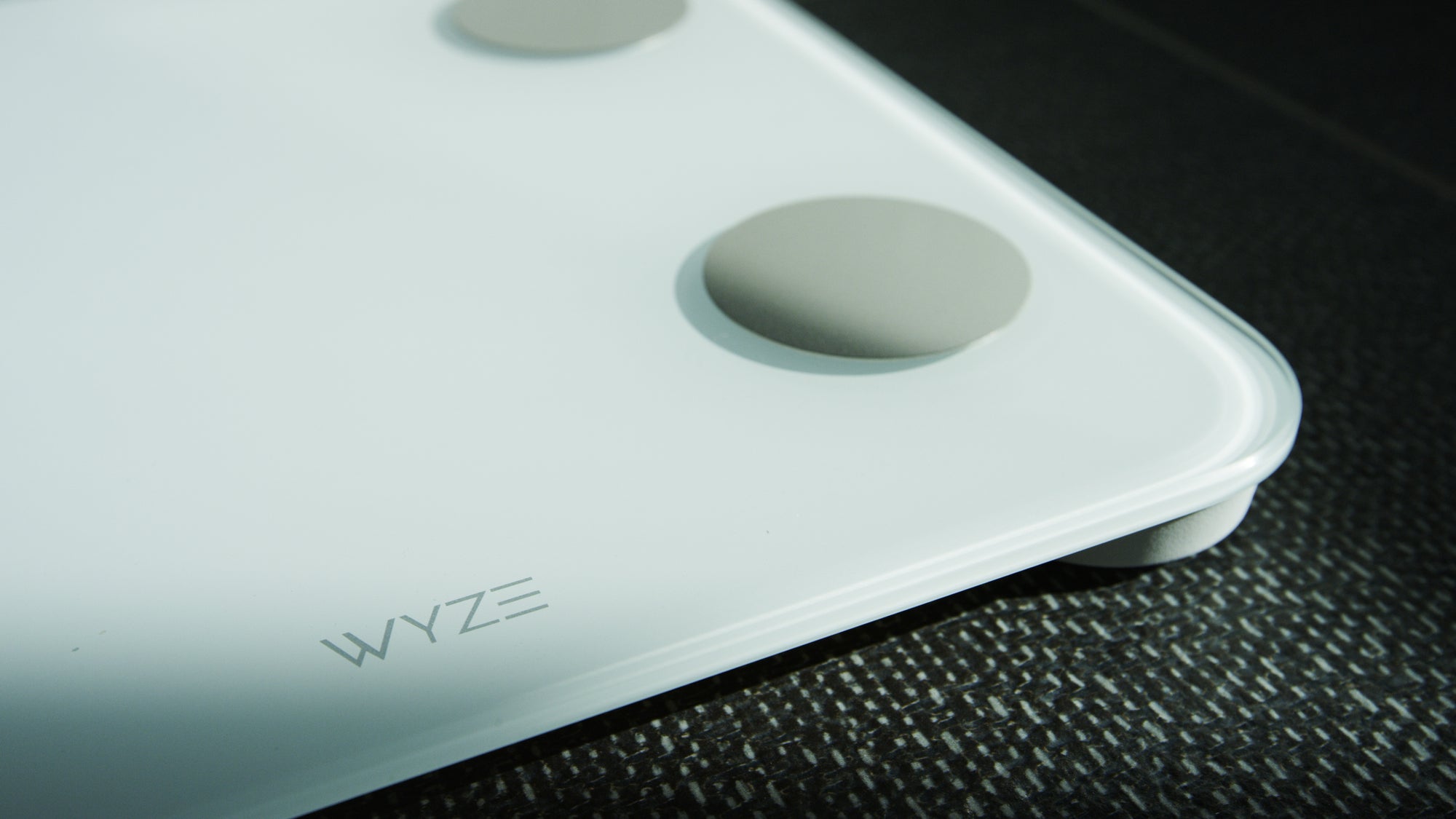 A white Wyze scale with a close up of the buttons.