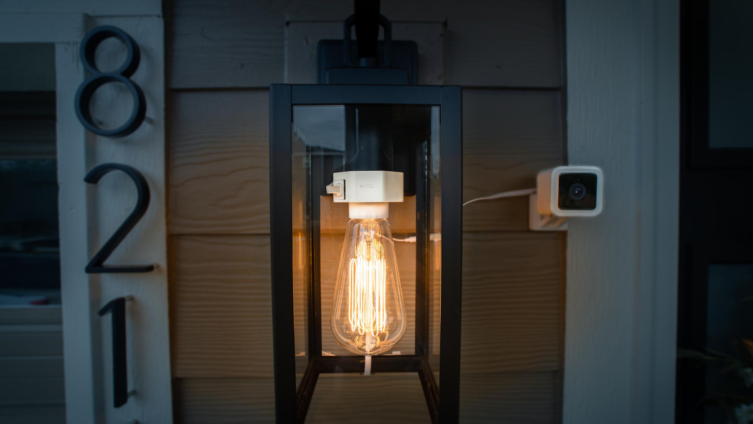 Wyze Lamp Socket powering an Edison bulb outside with a Wyze Cam v3 attached to the outlet built into the socket.