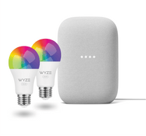A white and grey speaker with a rainbow colored light on top.