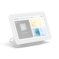 A white device with a screen displaying music and weather information.