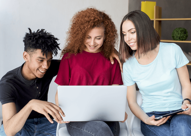 Friends looking at a laptop