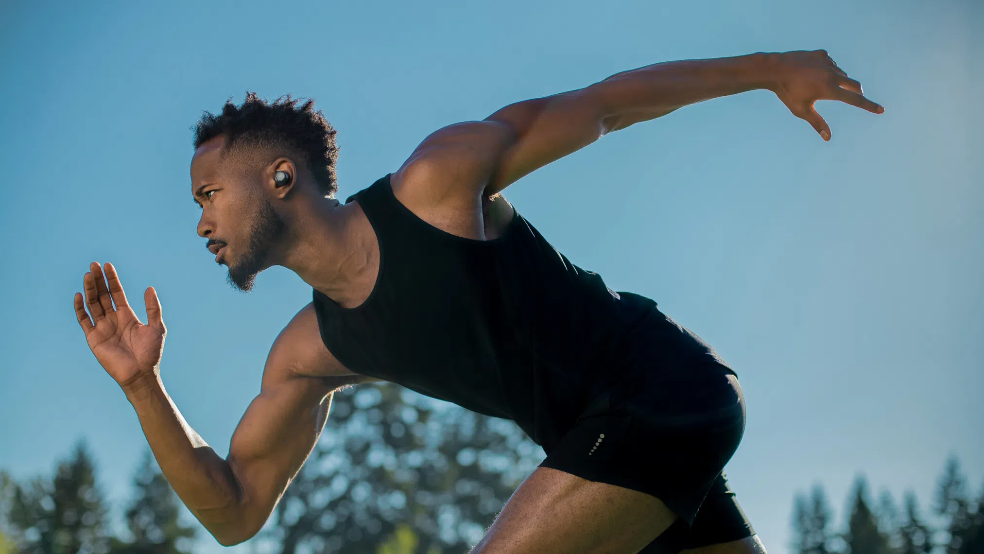 Person getting ready to run wearing Wyze Buds.