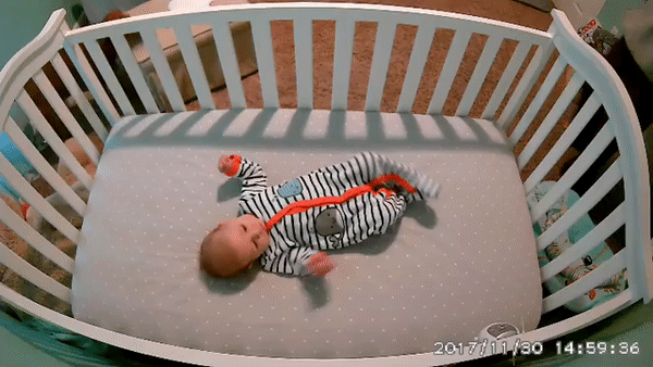A baby laying in a crib. 5