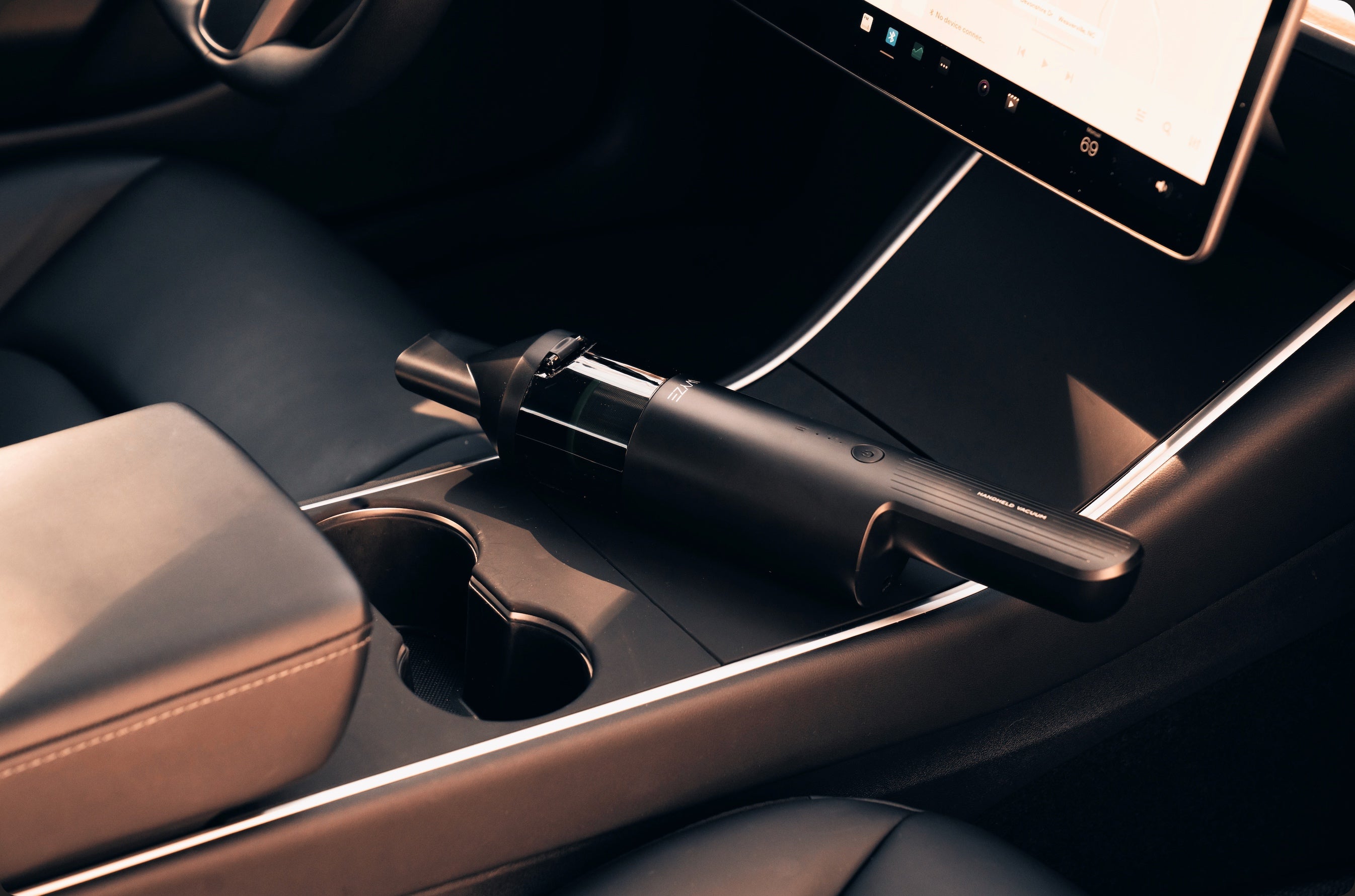 A vacuum cleaner in a car.