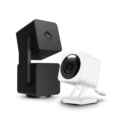 A white and black camera next to each other.