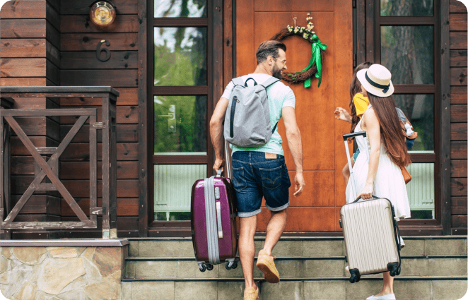 A man and woman are walking up a staircase with their luggage, likely going on a vacation.