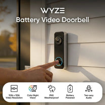 A person is pressing a button on a doorbell.