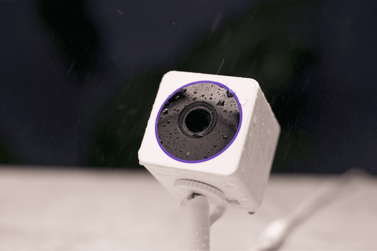 Water drops falling onto a security camera.